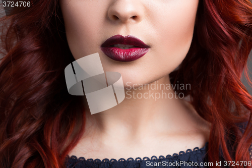 Image of closeup cherry lips. girl with red hair. the lower part of the face. Fashion Girl Portrait.