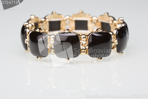 Image of Bracelet with black  stones over white