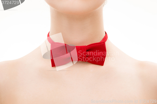 Image of red tie bow on female neck. 