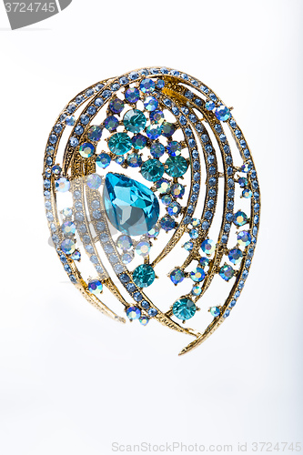Image of brooch with colored stones 