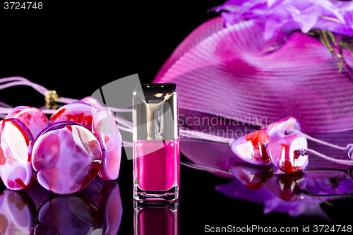 Image of magenta nail polish on  background of women\'s accessories