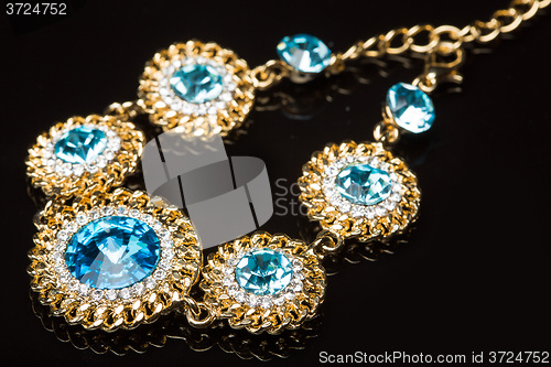 Image of Bracelet with blue stones over black 