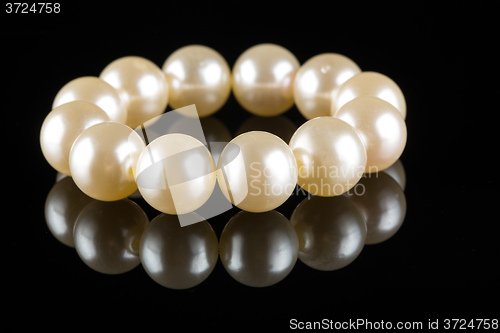 Image of White pearls on  black  background. luxury bracelet.