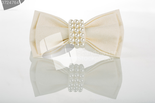 Image of white bow tie with pearls