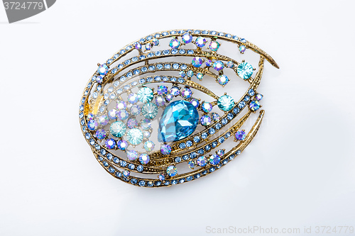 Image of brooch with colored stones 