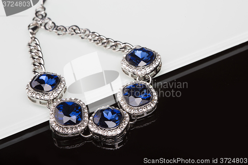 Image of Bracelet with blue stones over black 