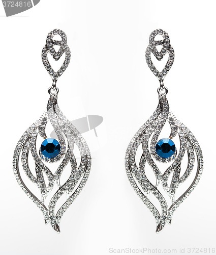 Image of earrings with blue stones on the white