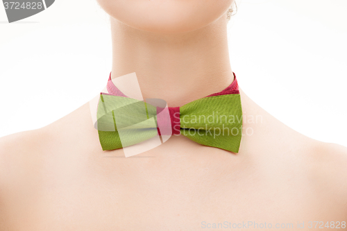 Image of green tie bow on female neck. 