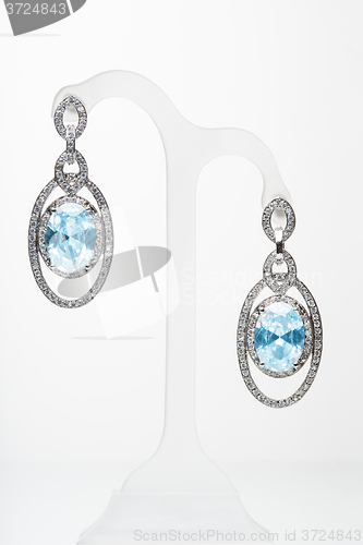 Image of earrings with blue stones on the white