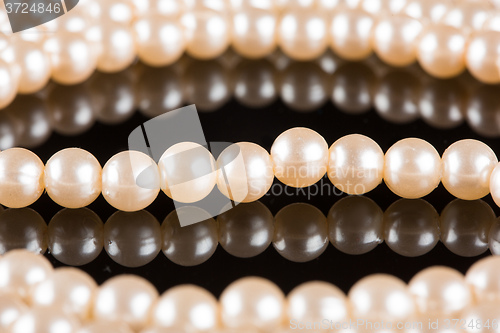 Image of White pearls on  black  background. luxury necklace.