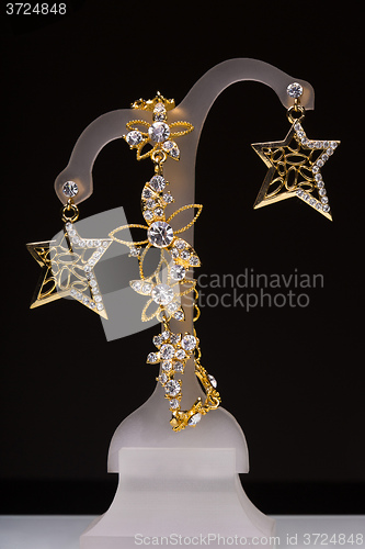 Image of gold pendant and earrings in the form of stars