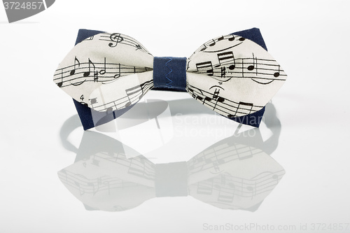 Image of white bow tie with notes on a white background 