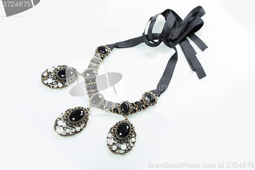 Image of black necklace with stones on white 