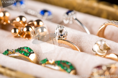 Image of box with jewelery. Rings and pendants. 