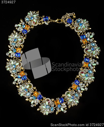 Image of plastic necklace with colored stones