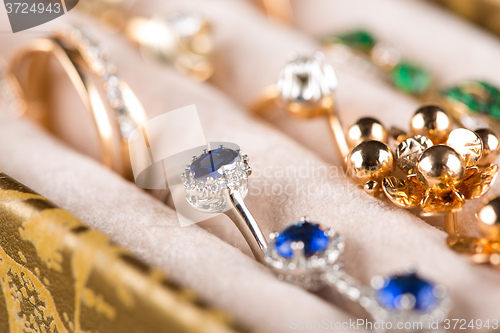 Image of box with jewelery. Rings and pendants. 