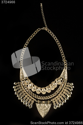 Image of metal feminine necklace. on black  background. 