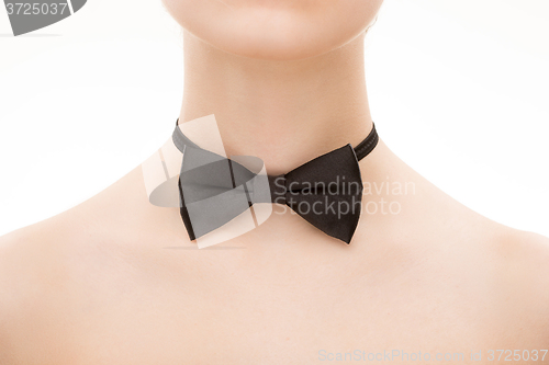 Image of black tie bow on female neck. 