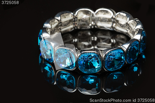 Image of Bracelet with blue stones over black 