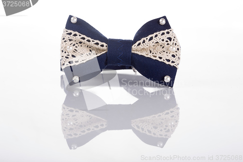 Image of blue bow tie with white lace