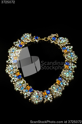 Image of plastic necklace with colored stones