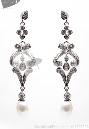 Image of earrings with blue stones on the white