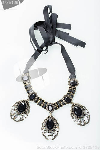 Image of black necklace with stones on white 