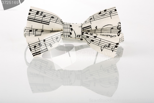 Image of white bow tie with notes on a white background 