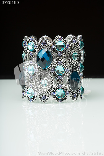 Image of Bracelet with blue stones over black 