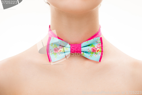 Image of patterned tie bow on female neck. 