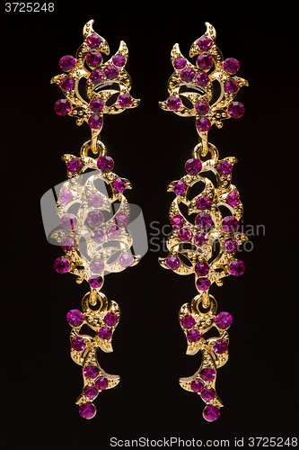 Image of earring with colorful red gems 