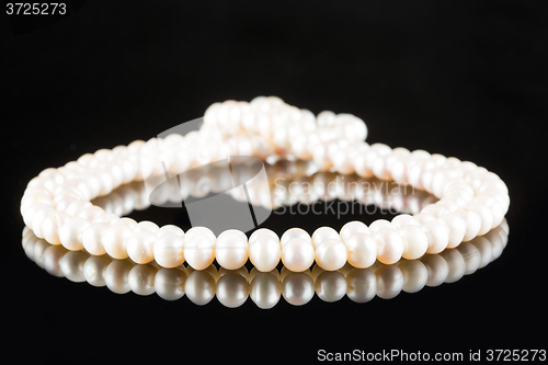 Image of White pearls on  black  background. luxury necklace.