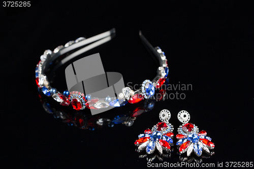 Image of diadem with large colored stones. bijouterie. on black background
