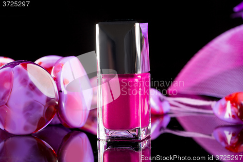 Image of magenta nail polish on  background of women\'s accessories