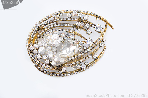 Image of Round golden brooch with diamonds 