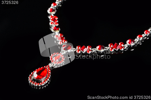 Image of Vintage pendant with ruby and crystals on   black background