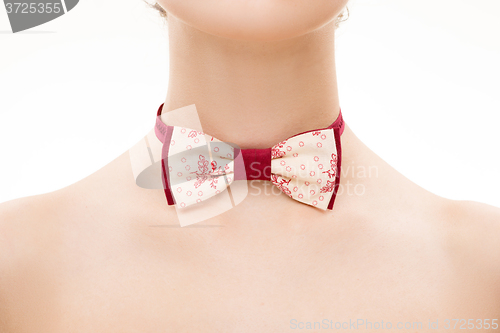 Image of patterned tie bow on female neck. 