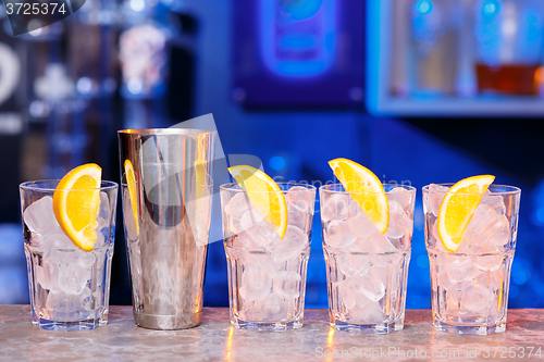 Image of Glasses with ice cubes on wooden table