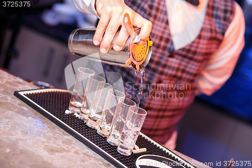 Image of Barman at work, preparing cocktails.