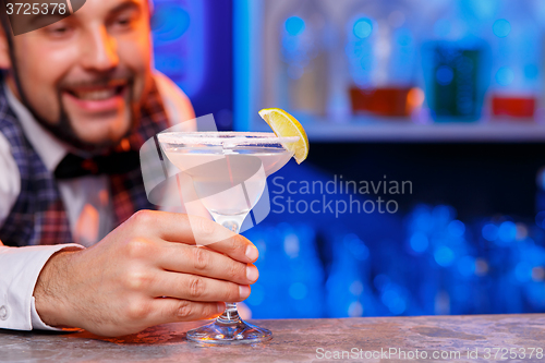 Image of Barman at work, preparing cocktails.