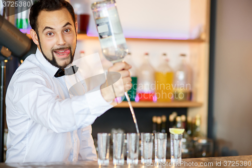 Image of Barman at work, preparing cocktails.