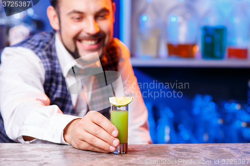 Image of Barman at work, preparing cocktails.