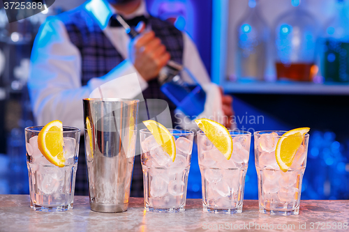 Image of Barman at work, preparing cocktails.