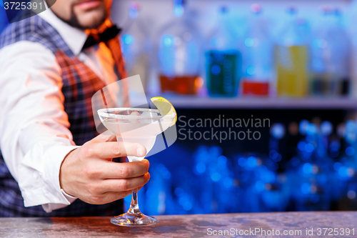 Image of Barman at work, preparing cocktails.