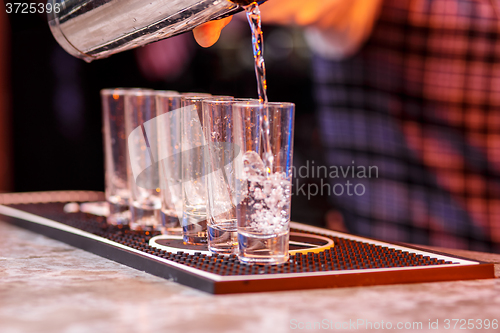 Image of Barman at work, preparing cocktails.