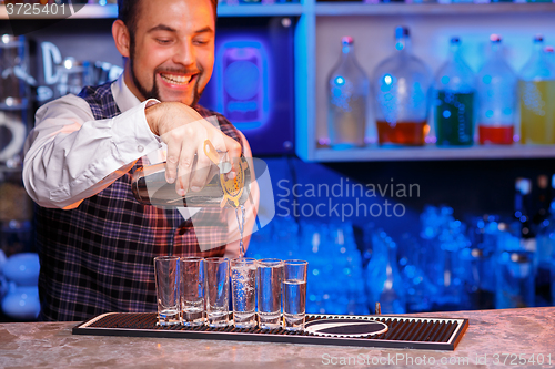 Image of Barman at work, preparing cocktails.