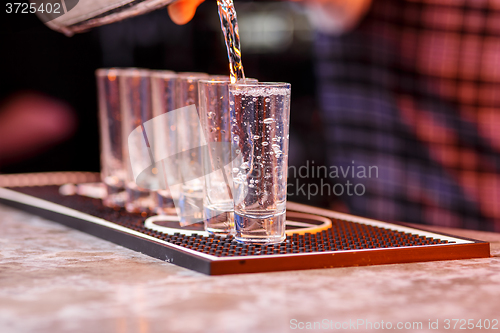 Image of Barman at work, preparing cocktails.