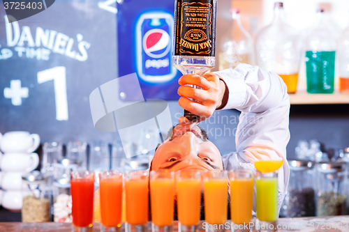 Image of Bar Poplavok, Dnepropetrovsk, Ukraine - December 23, 2015: The barman at work, he preparing cocktails