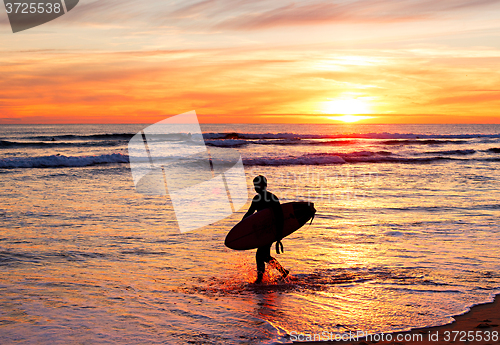 Image of Surfing at sunset, Portugal