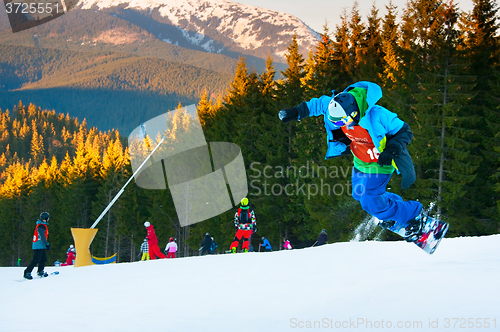 Image of Snowboarder jumping at ski resort